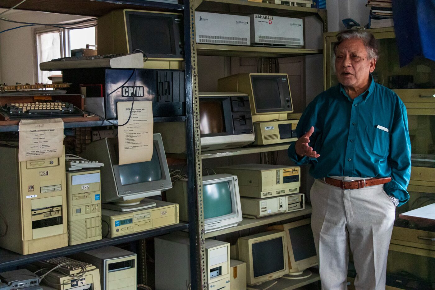 Muni Bahadur Sakya standing beside Nepal's first supercomputer